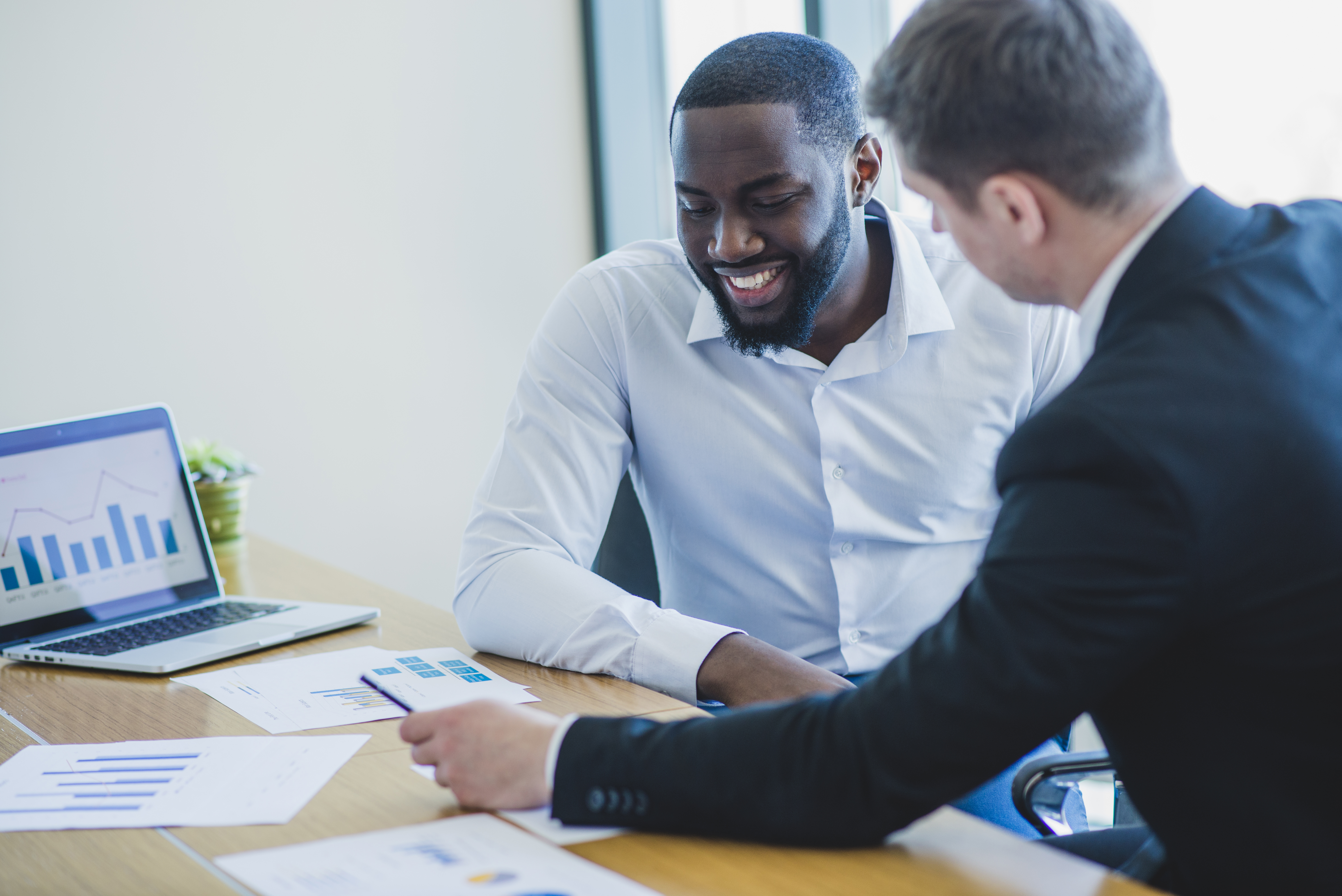 Two businessmen reviewing marketing strategy